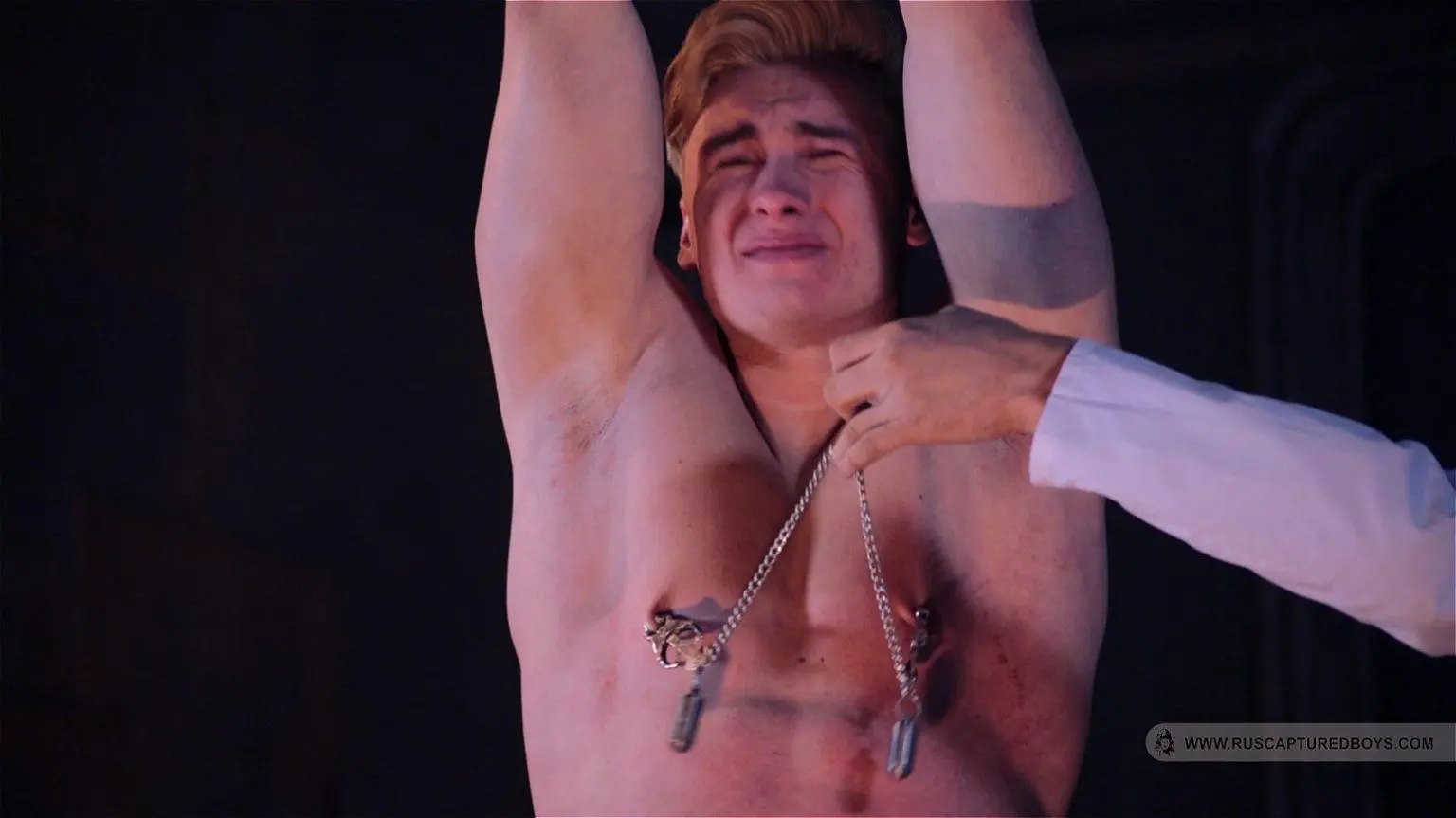 Nipples torture by the clamps and additional weights. A pic from RusCapturedBoys.com video “New Talent Sergei - Final Part”.