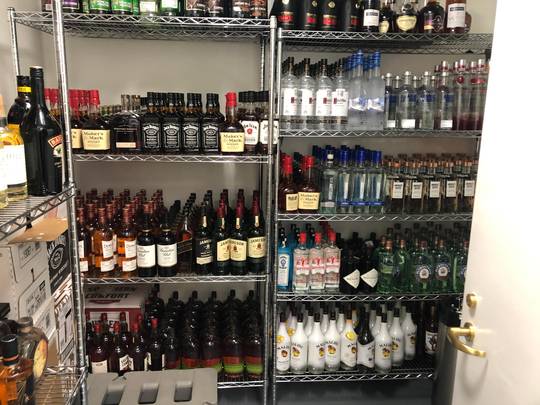 Organized liquor closet at work.