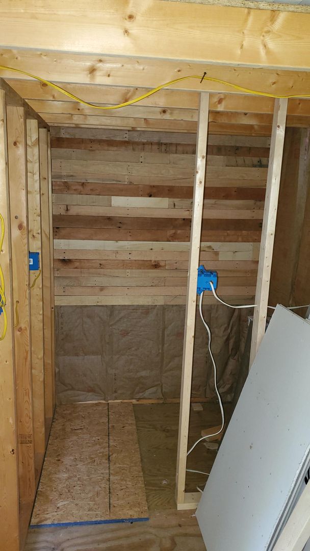 Pallet wood walls going on at the off grid cabin.