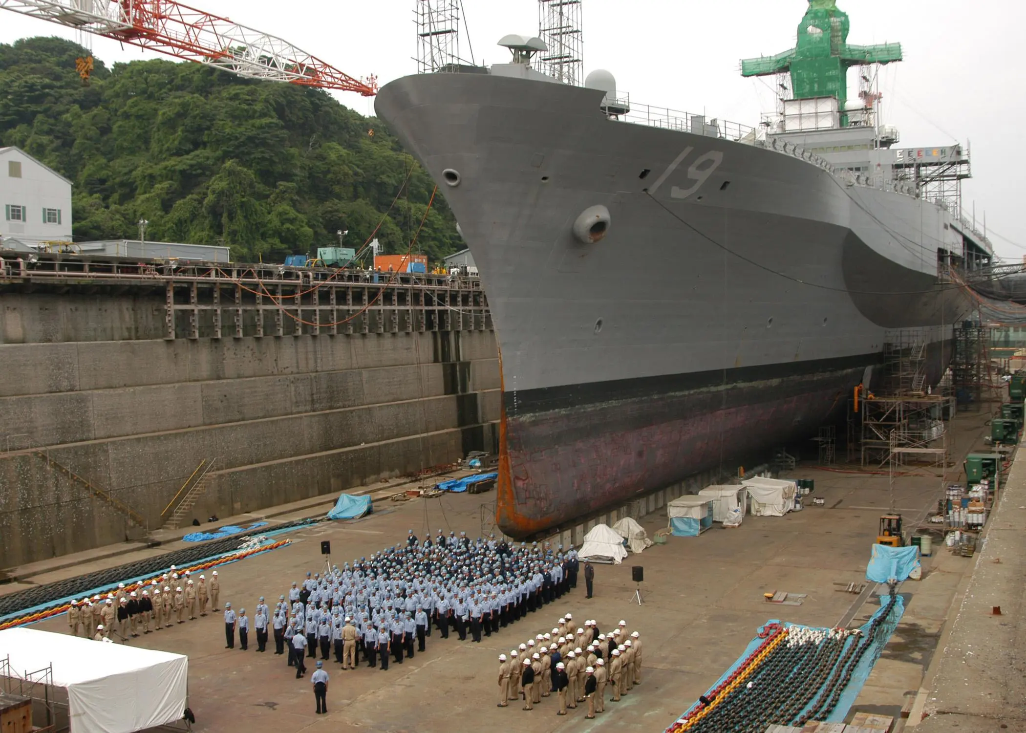 Promotion ceremony takes place in front of the command ship USS Blue ...