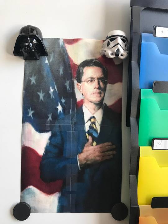 Right underneath the flag in my classroom