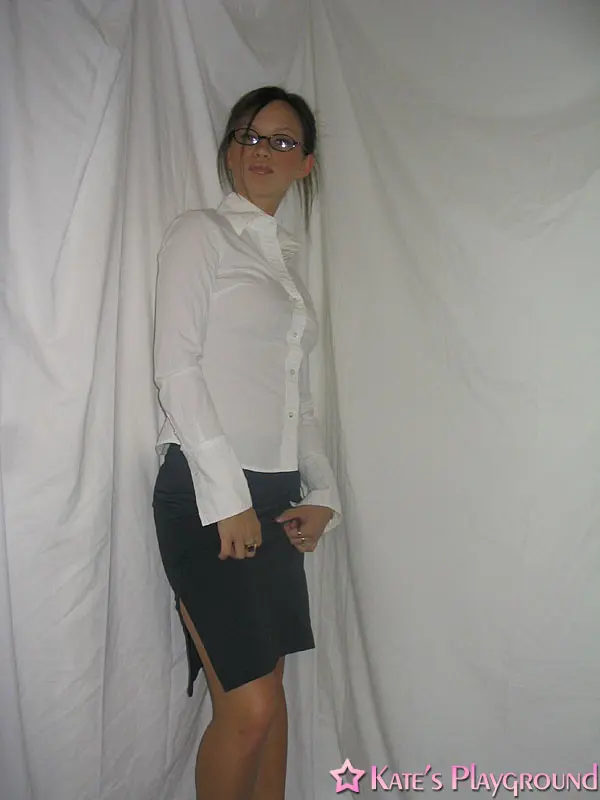 Kate in a sexy teacher outfit featuring a white blouse, tight grey pencil skirt, and glasses
