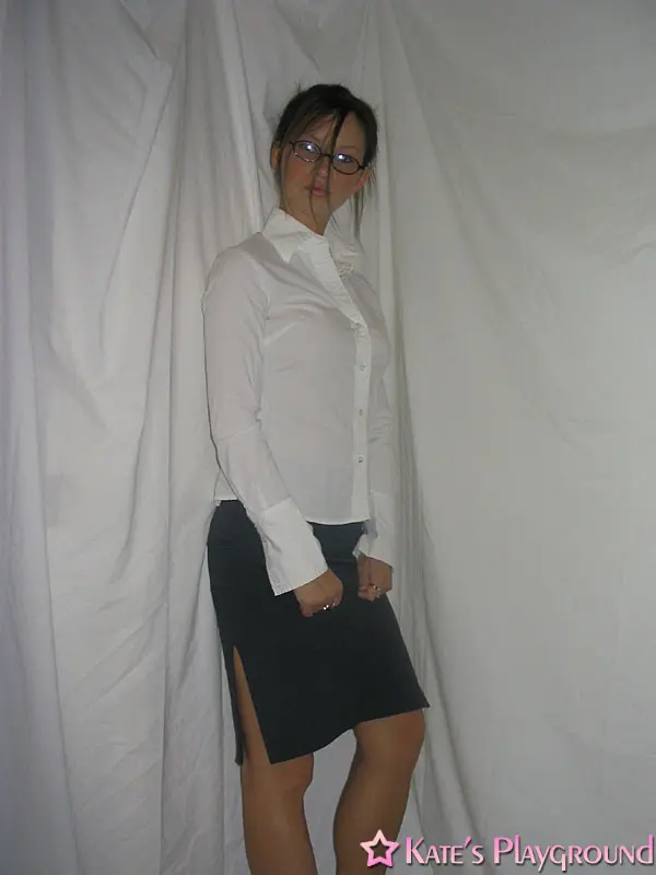 Kate in a sexy teacher outfit featuring a white blouse, tight grey pencil skirt, and glasses