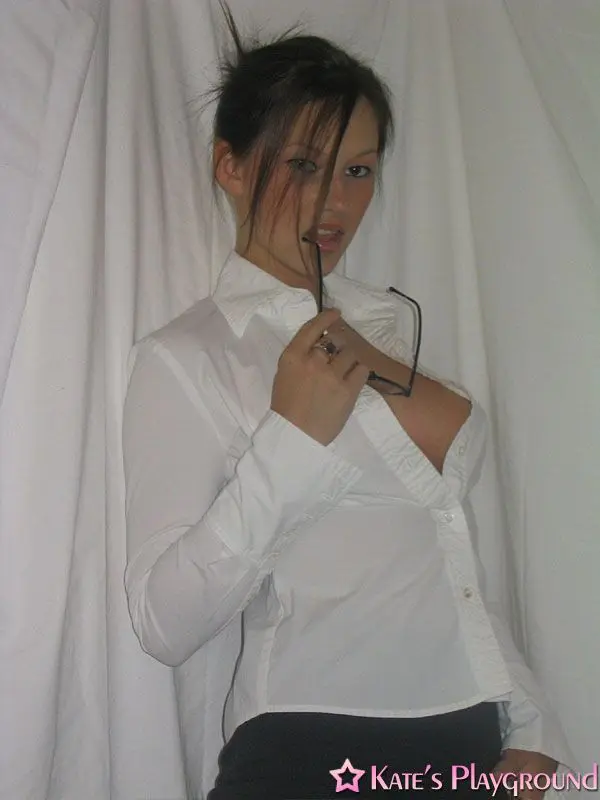 Kate in a sexy teacher outfit featuring a white blouse, tight grey pencil skirt, and glasses