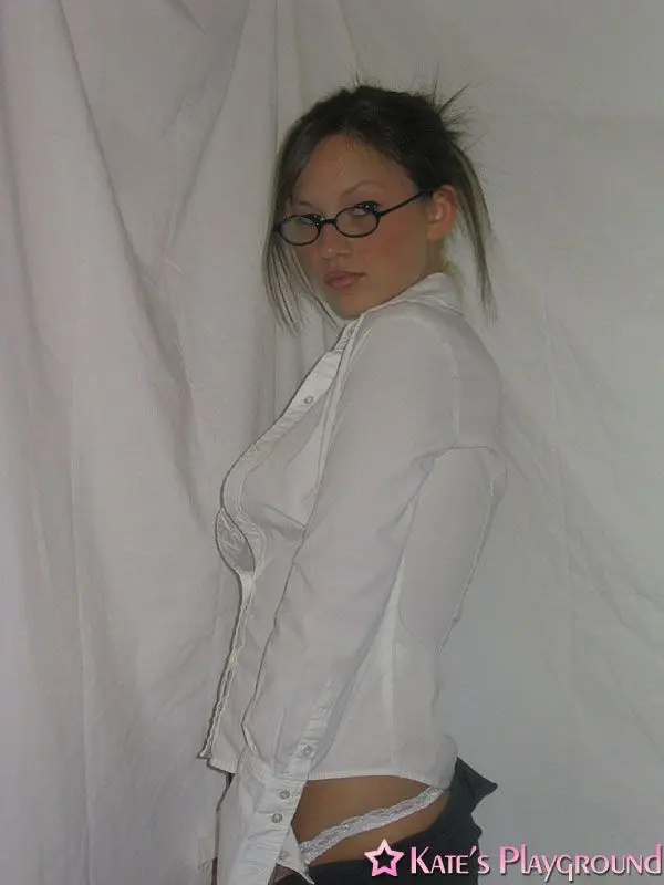 Kate in a sexy teacher outfit featuring a white blouse, tight grey pencil skirt, and glasses