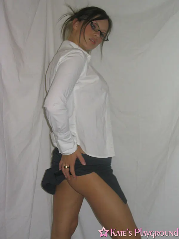 Kate in a sexy teacher outfit featuring a white blouse, tight grey pencil skirt, and glasses