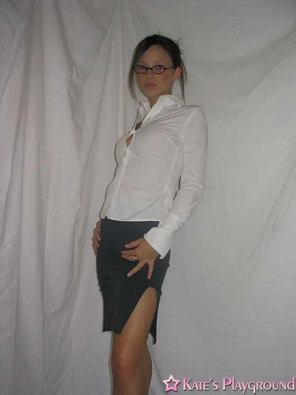 Kate in a sexy teacher outfit featuring a white blouse, tight grey pencil skirt, and glasses
