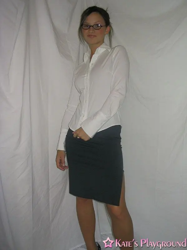 Kate in a sexy teacher outfit featuring a white blouse, tight grey pencil skirt, and glasses