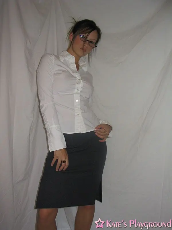 Kate in a sexy teacher outfit featuring a white blouse, tight grey pencil skirt, and glasses