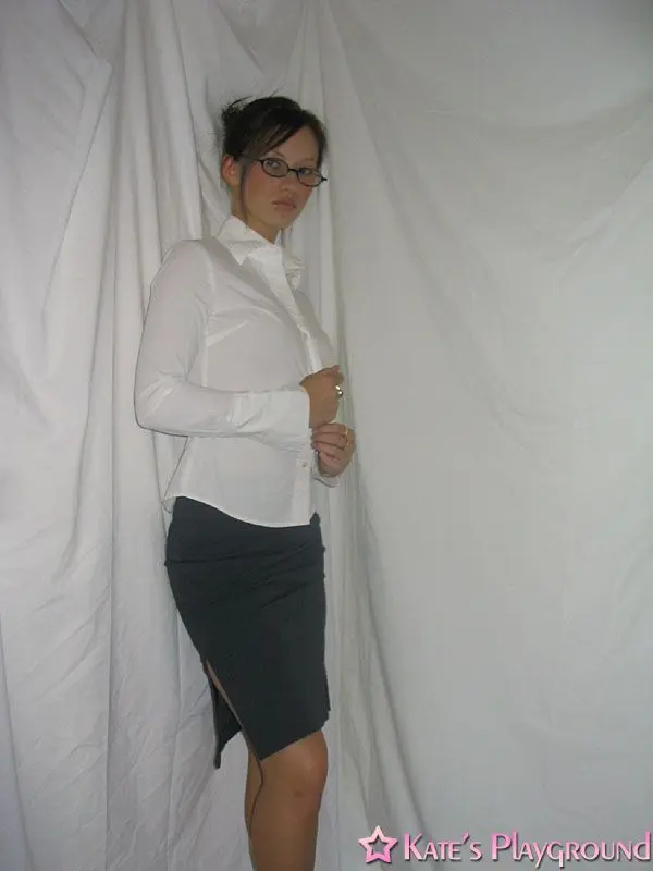 Kate in a sexy teacher outfit featuring a white blouse, tight grey pencil skirt, and glasses
