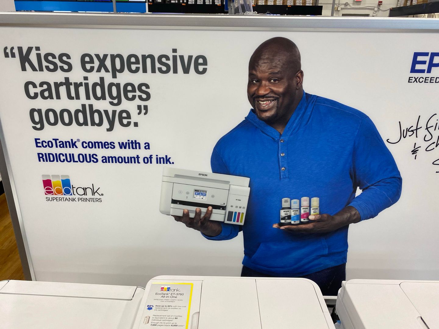 Shaq holding a printer and ink