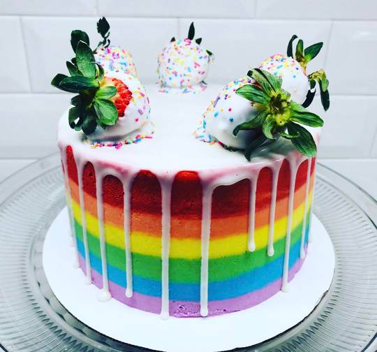 Strawberry rainbow cake with white chocolate drip and white chocolate dipped strawberries