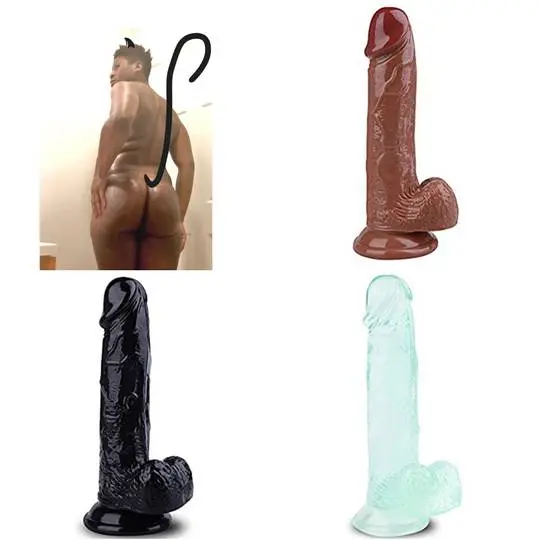 Muscular ebony catboy posing with a devil tail and three dildos in brown, black, and light blue.