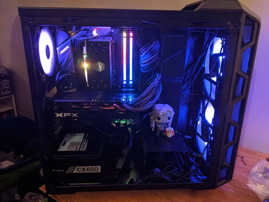 Dark Crystal: Age of Resistance inspired gaming pc build with blue lighting and a figurine inside the case