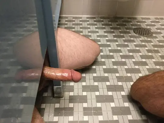 Athletic white man with a thick uncut erection posing for a pelfie in a bathroom.