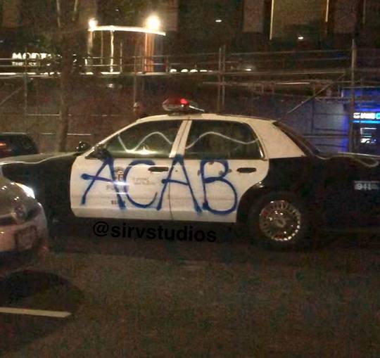 Vandalized L.A. Police car reading “ACAB” from the downtown riot/looting on Friday night