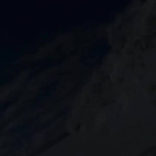 Wave crashing over a photographer