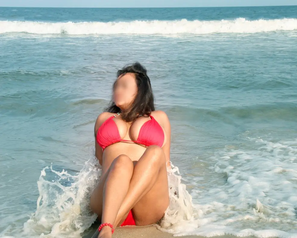 Curvy Indian bhabhi in a red bikini and turquoise sarong posing on a sandy beach