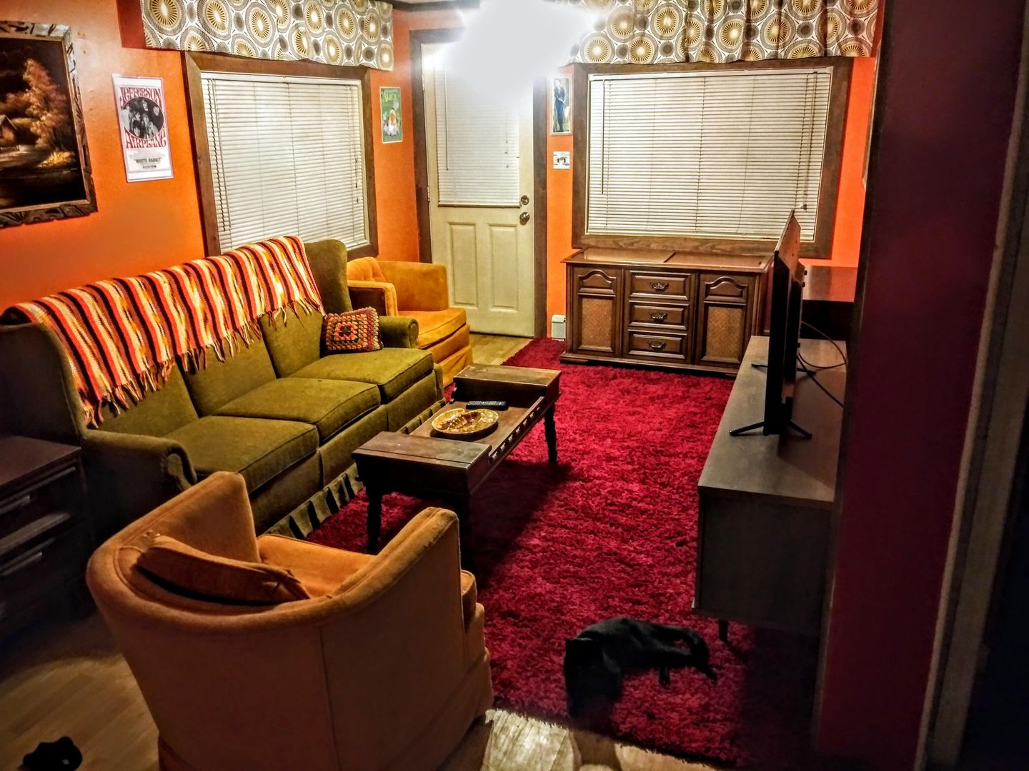 What do yall think of my 70s aesthetic livingroom? They blinds have been changed to brown. The door has been painted over to remove the nicotine stains of the previous owner