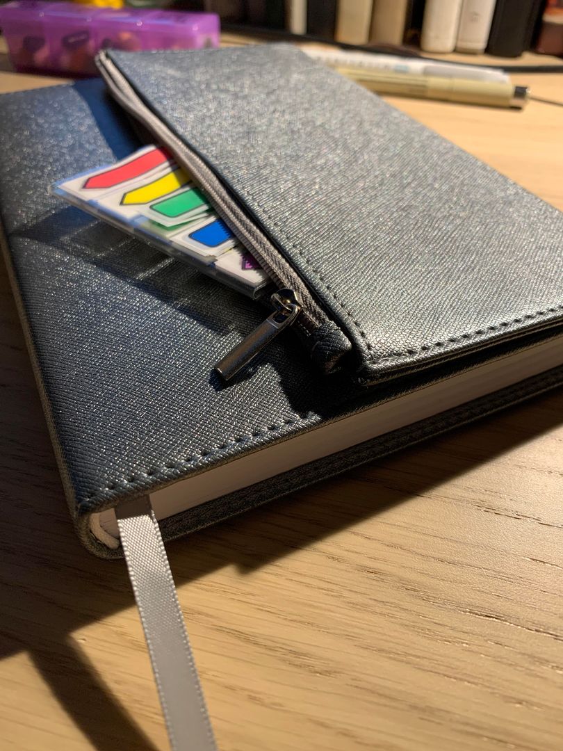 Wrap around notebook cover has a pouch for storage