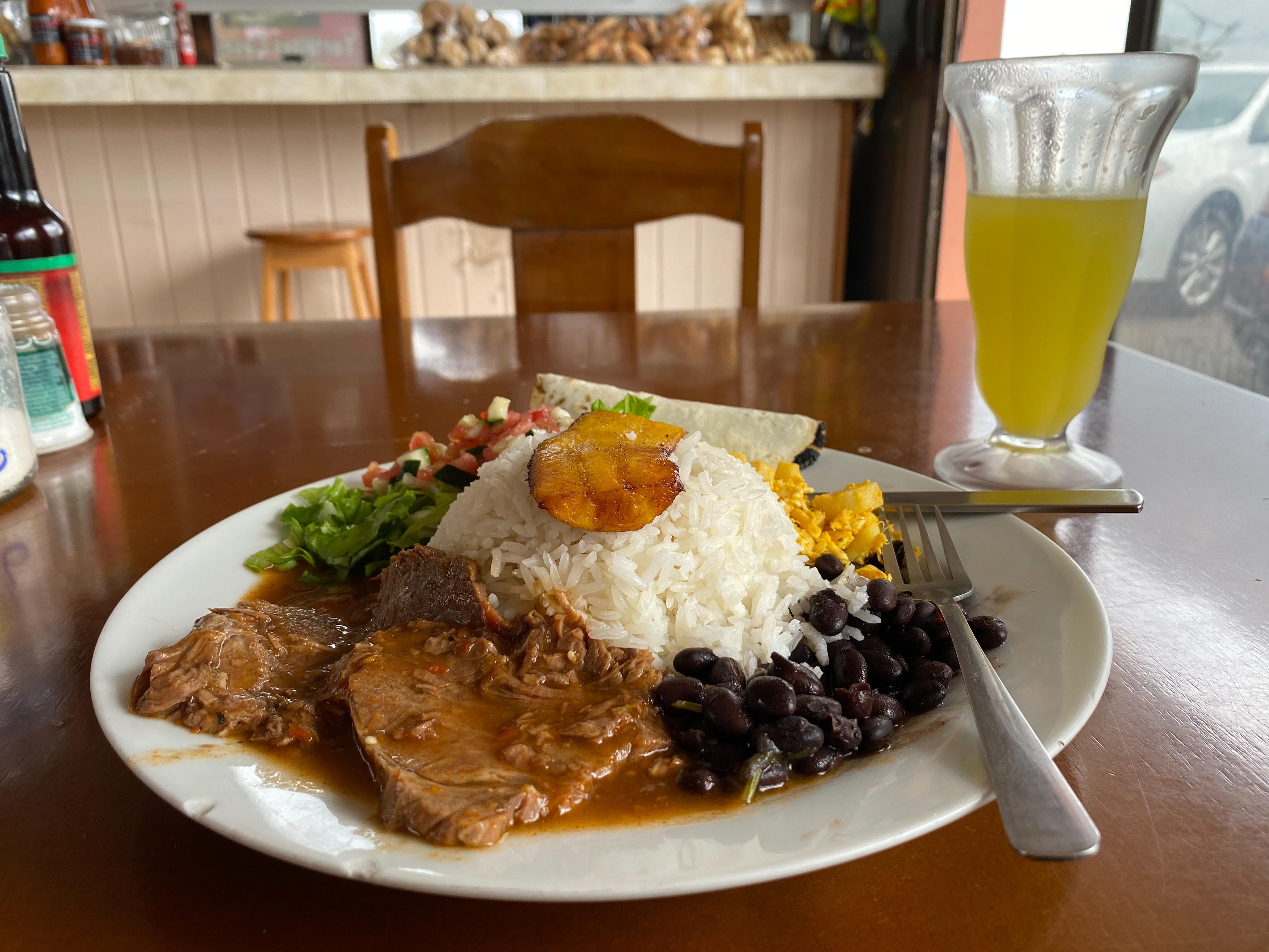 A typical Costa Rican meal: Rice & Beans with Chicken, topped with a ...
