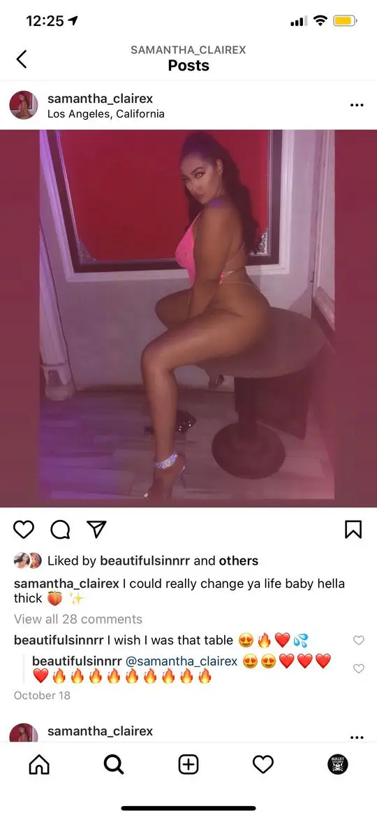 Samantha Claire posing on a table in a pink bikini