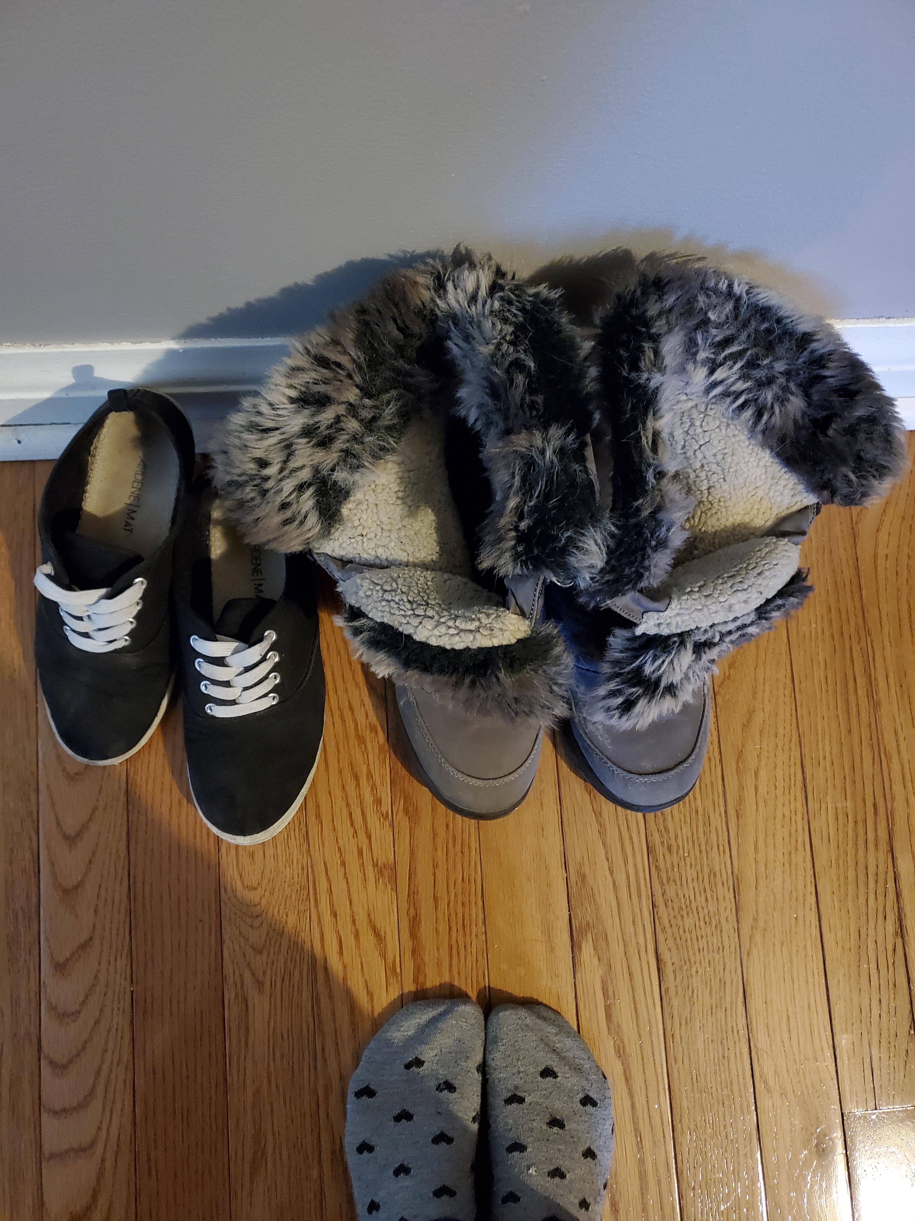 Black canvas tennis shoes and winter boots (worn all winter) still up