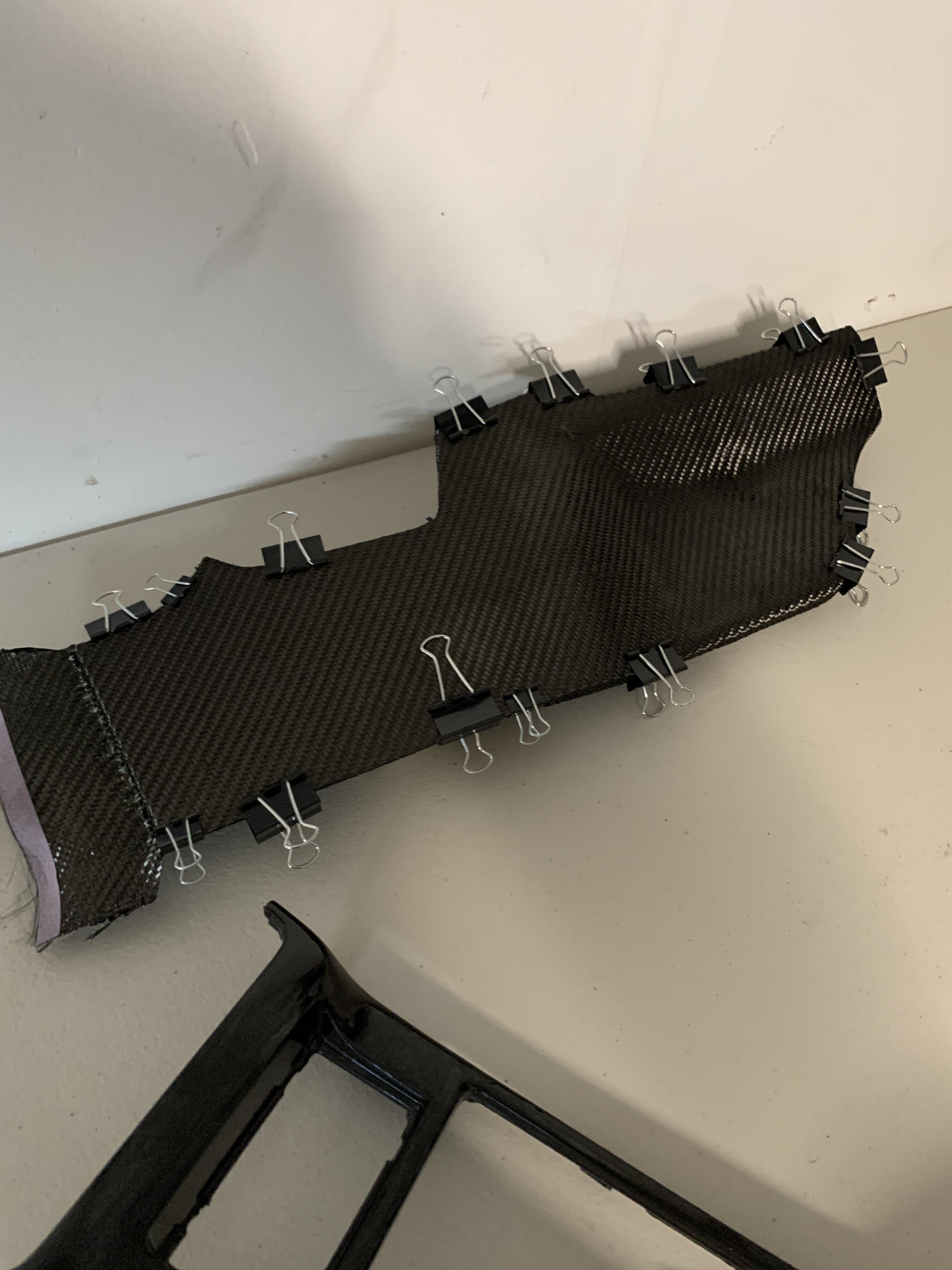 Carbon fiber skinning the Evo X center console footwells small detail