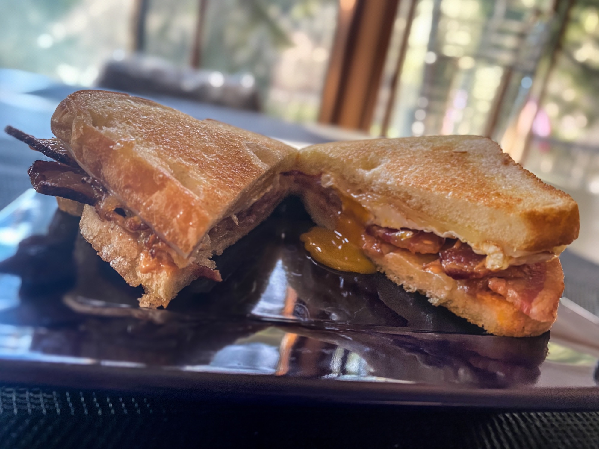 Grilled cheese breakfast sandwich w/ thick cut bacon, Havarti, Gouda
