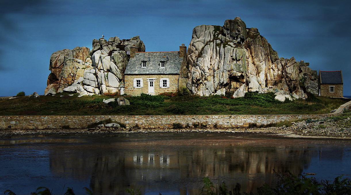 House built between granite rocks to protect from storms | Scrolller