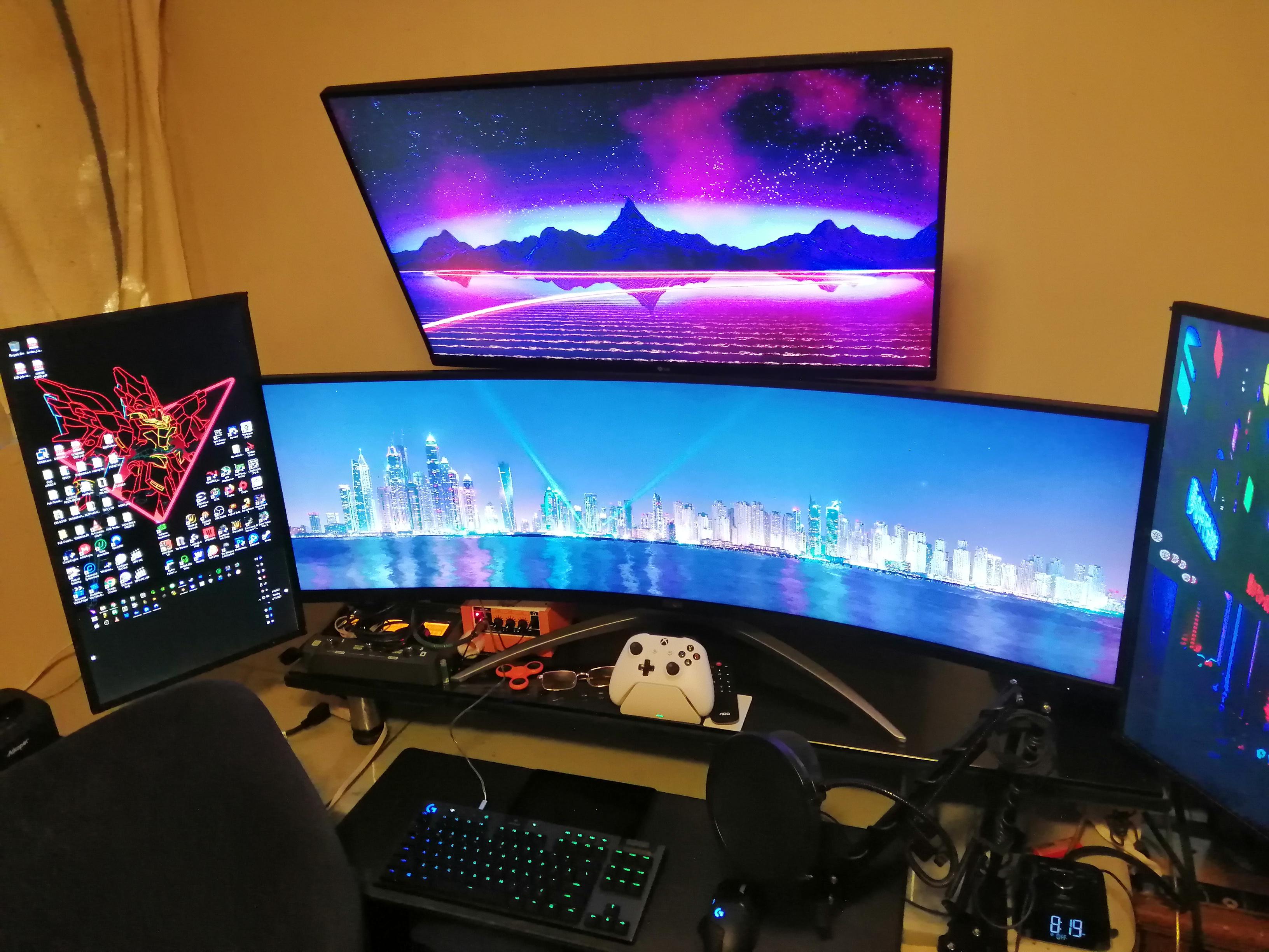 My Setup, Made a DIY riser that clamps the side and top monitors ...