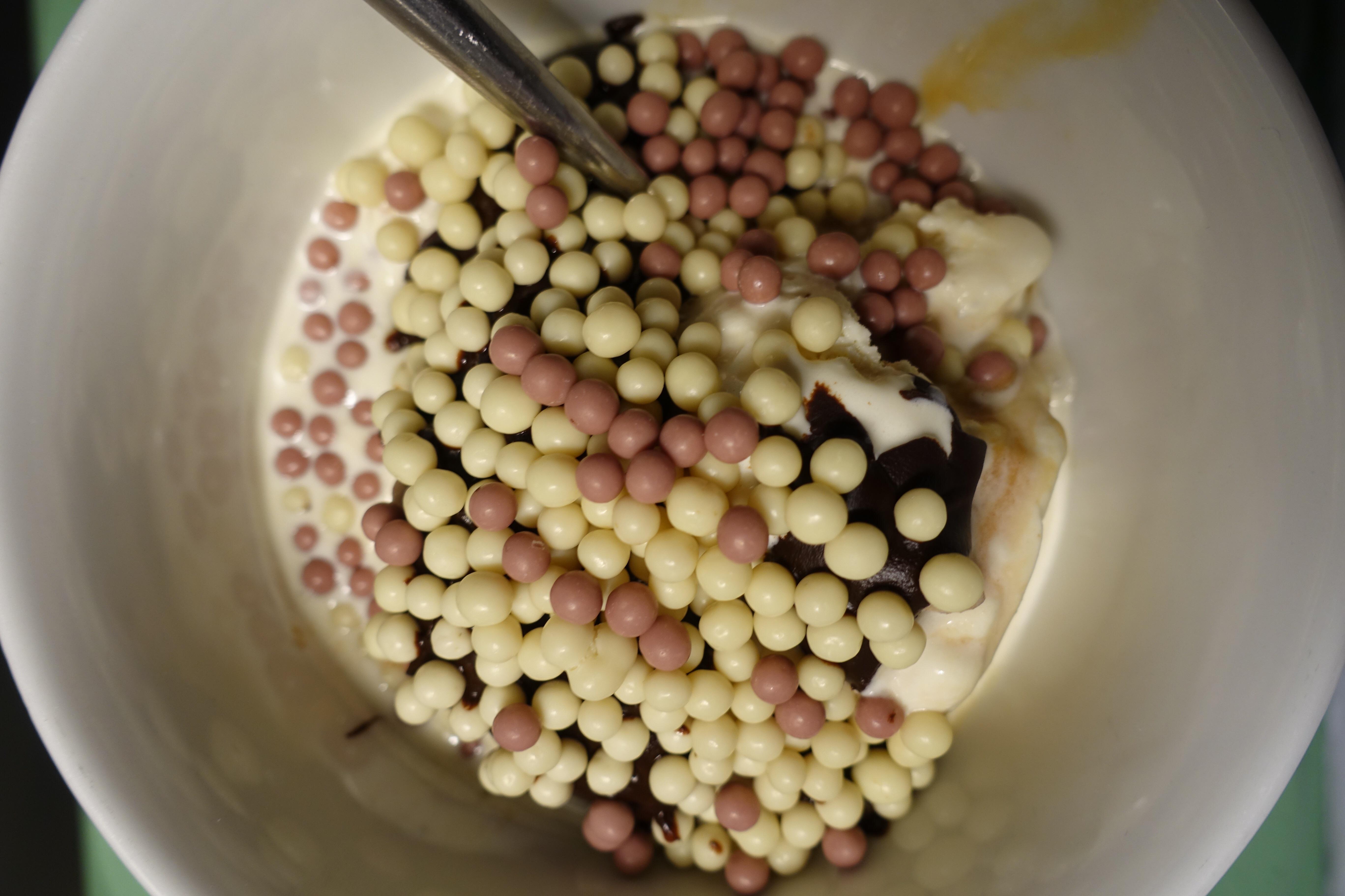 Pecan ice cream sundae, with dark chocolate sauce made with infused