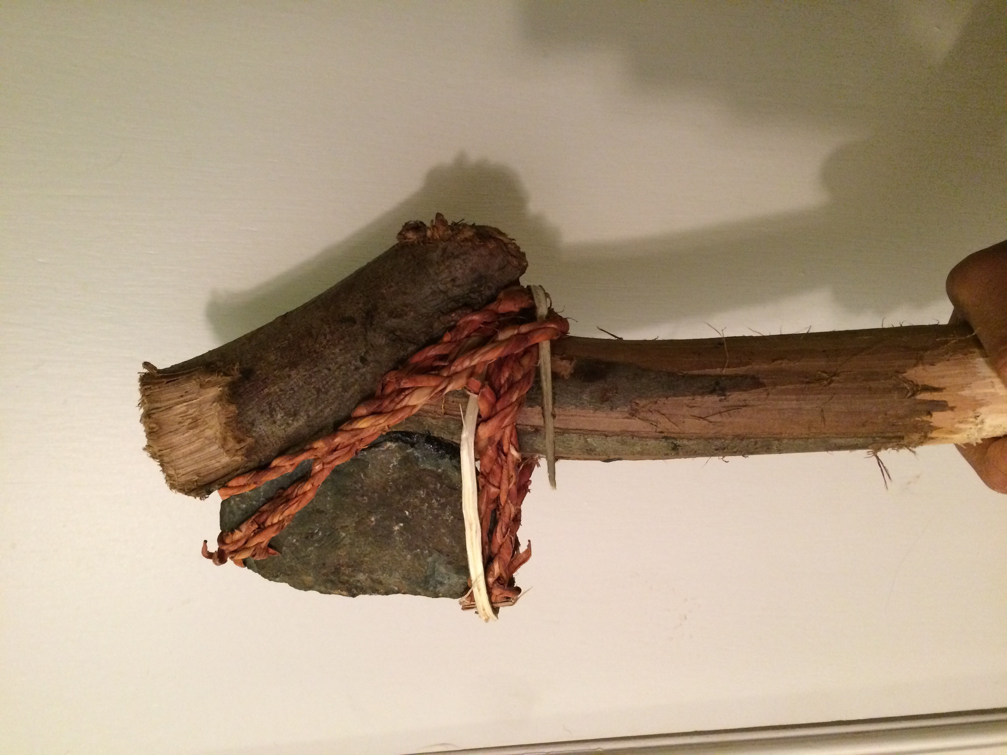 Stone axe. Secured with pine pitch and bark cordage. Scrolller