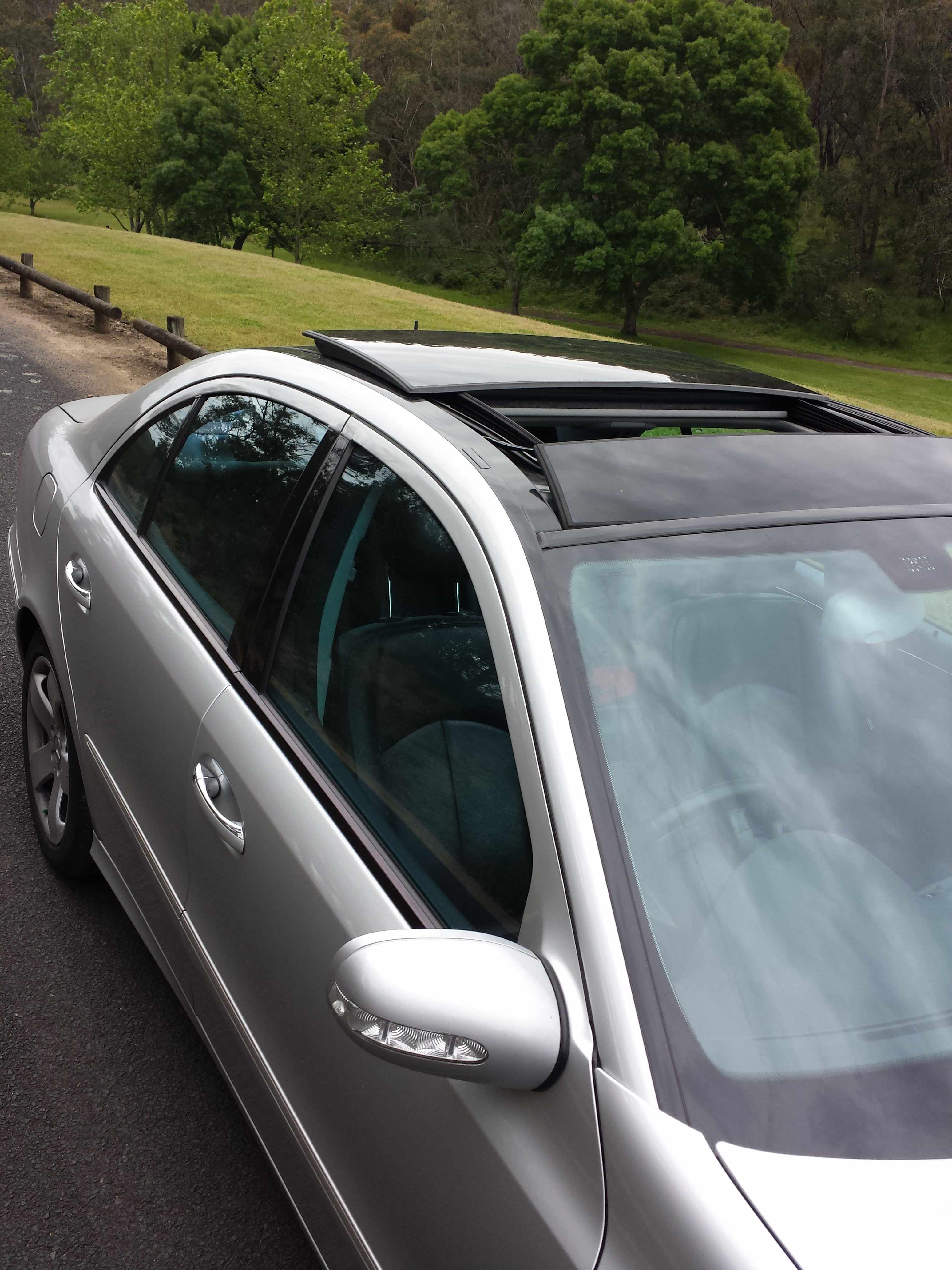 The W211 wind visor with an open panoramic sunroof Scrolller