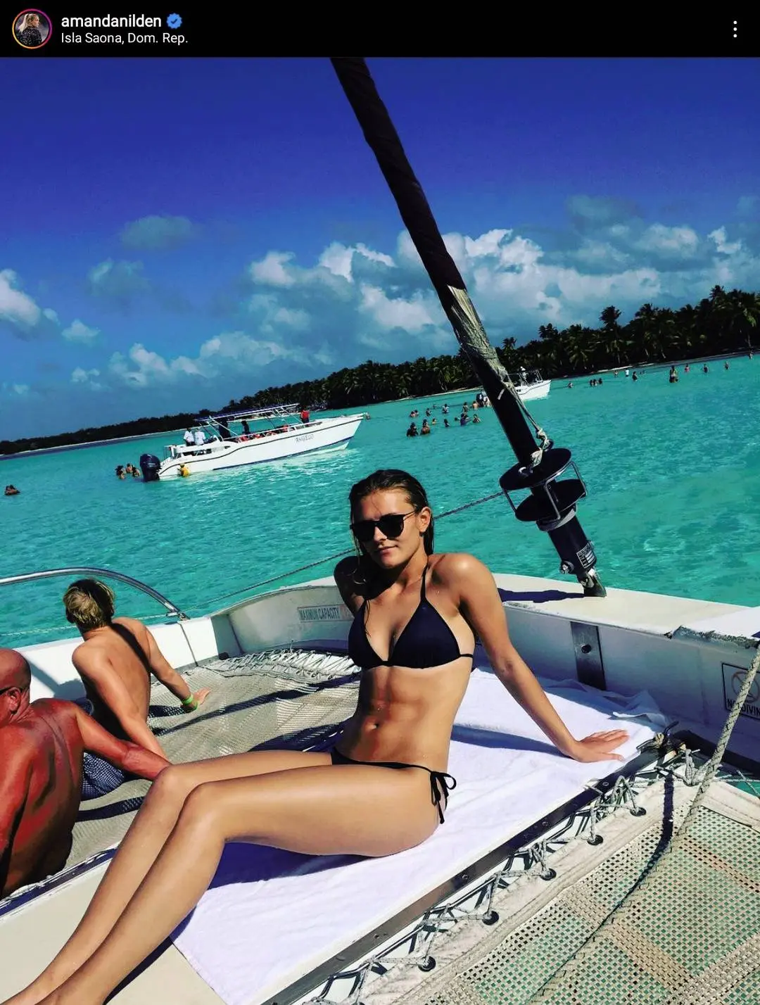 Amanda Nildén of Juventus Women in a black bikini relaxing on a boat's netting in a turquoise Caribbean sea