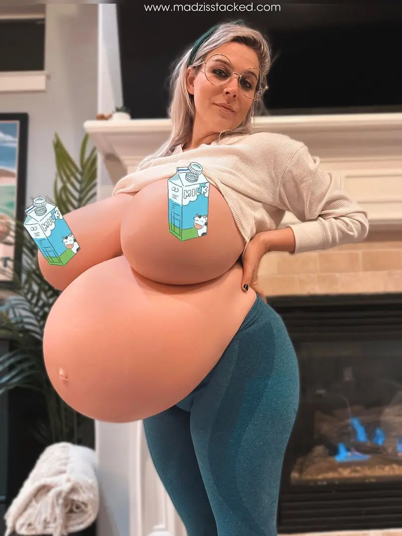 Madzisstacked with a hyper big belly and breasts in a white top and blue leggings