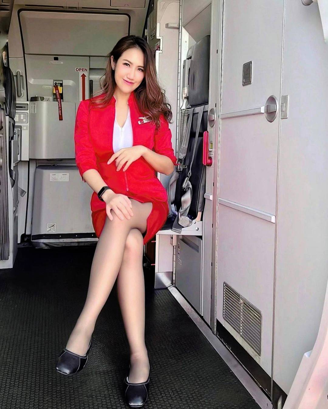 Flight attendant in a red uniform | Scrolller