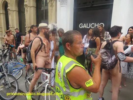 CFNM public exhibitionism with naked men and clothed women and men on a city street.