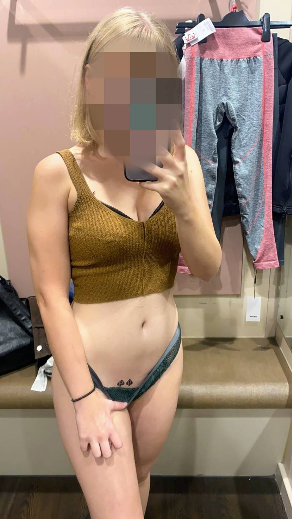 LittleObsessedx is spread out on a bed with spades on her body