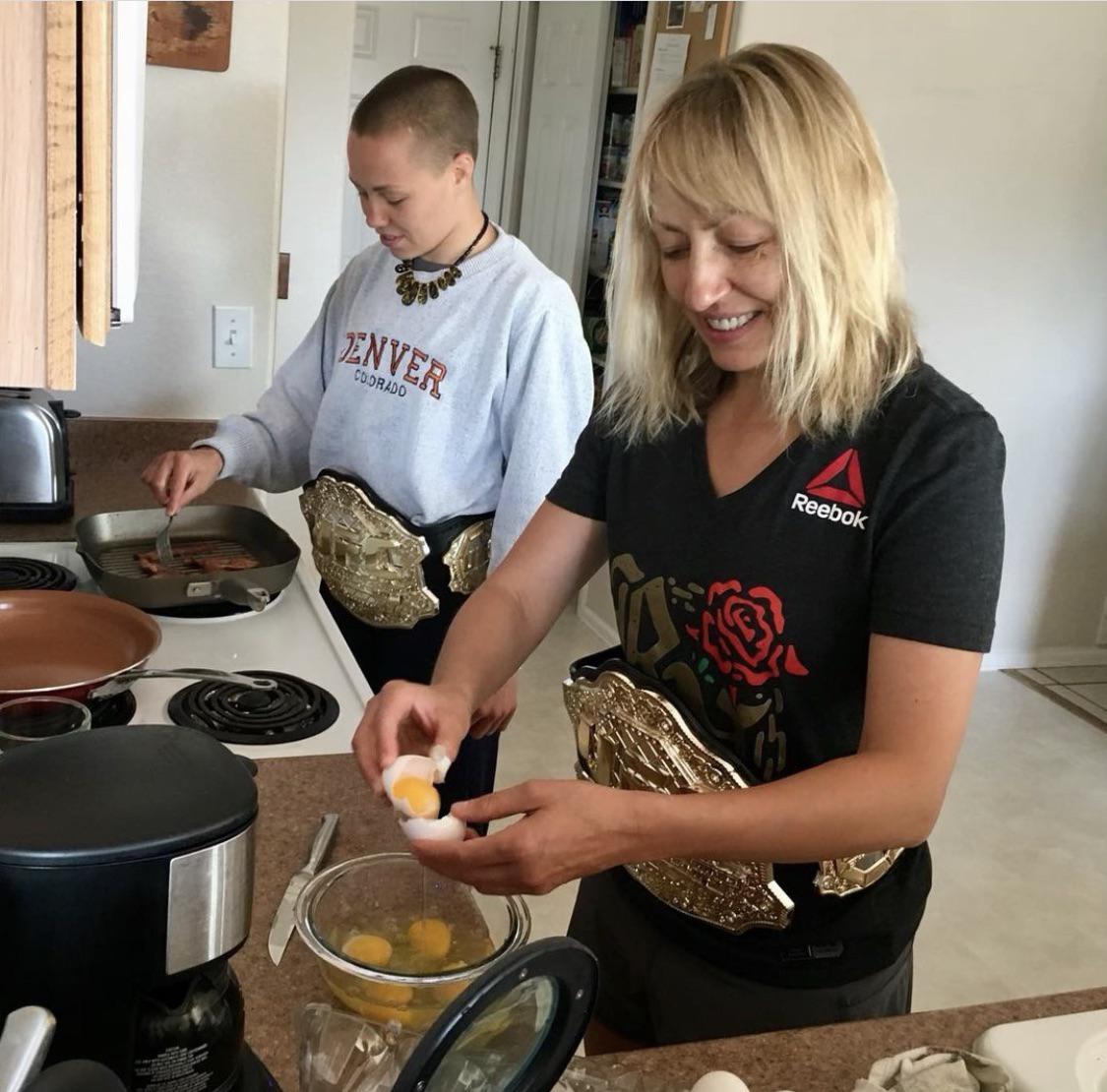 2 elite women wearing champ belts Scrolller