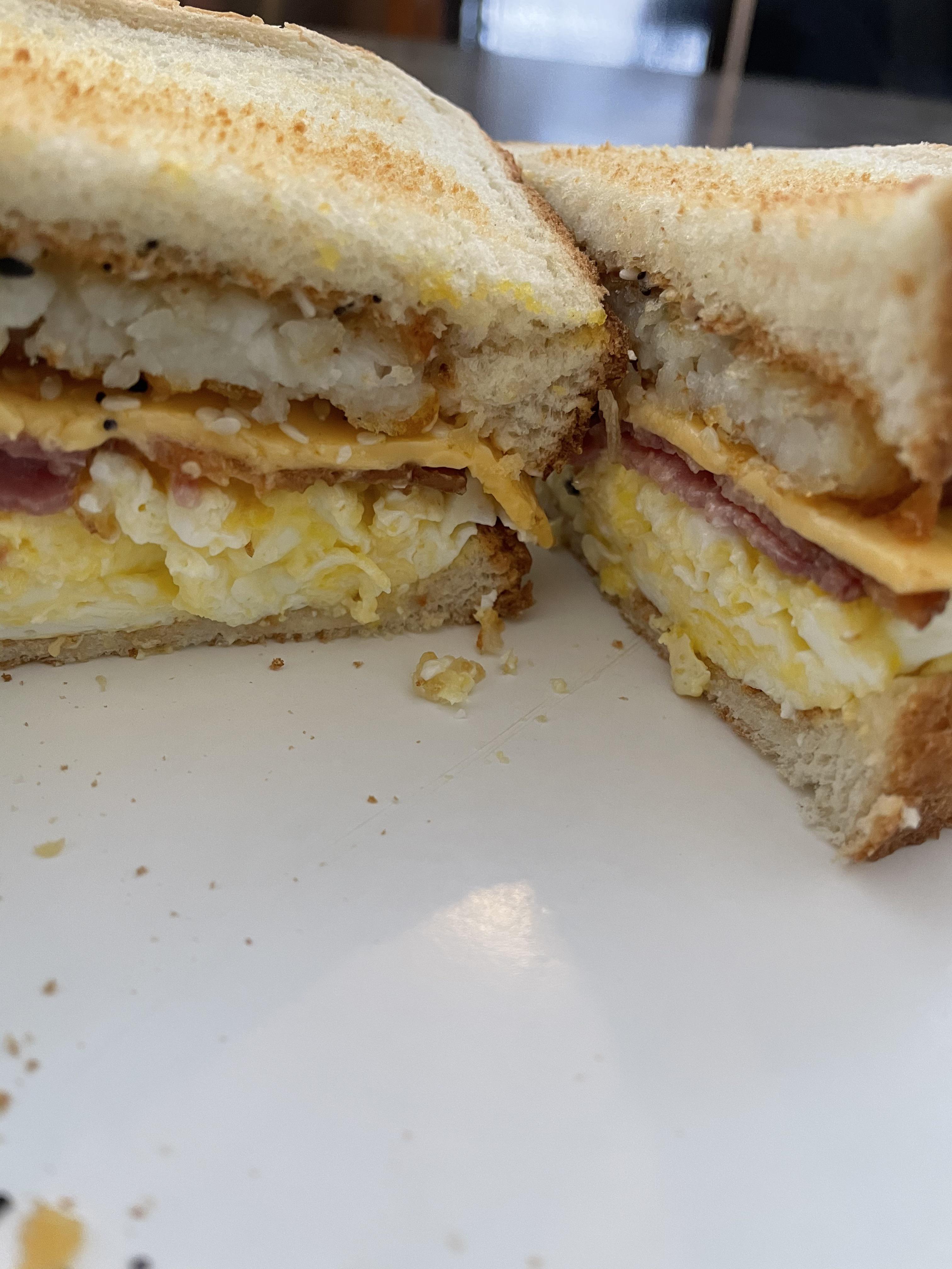 Bacon, scrambled eggs, velveeta cheese, hash brown patty, everything