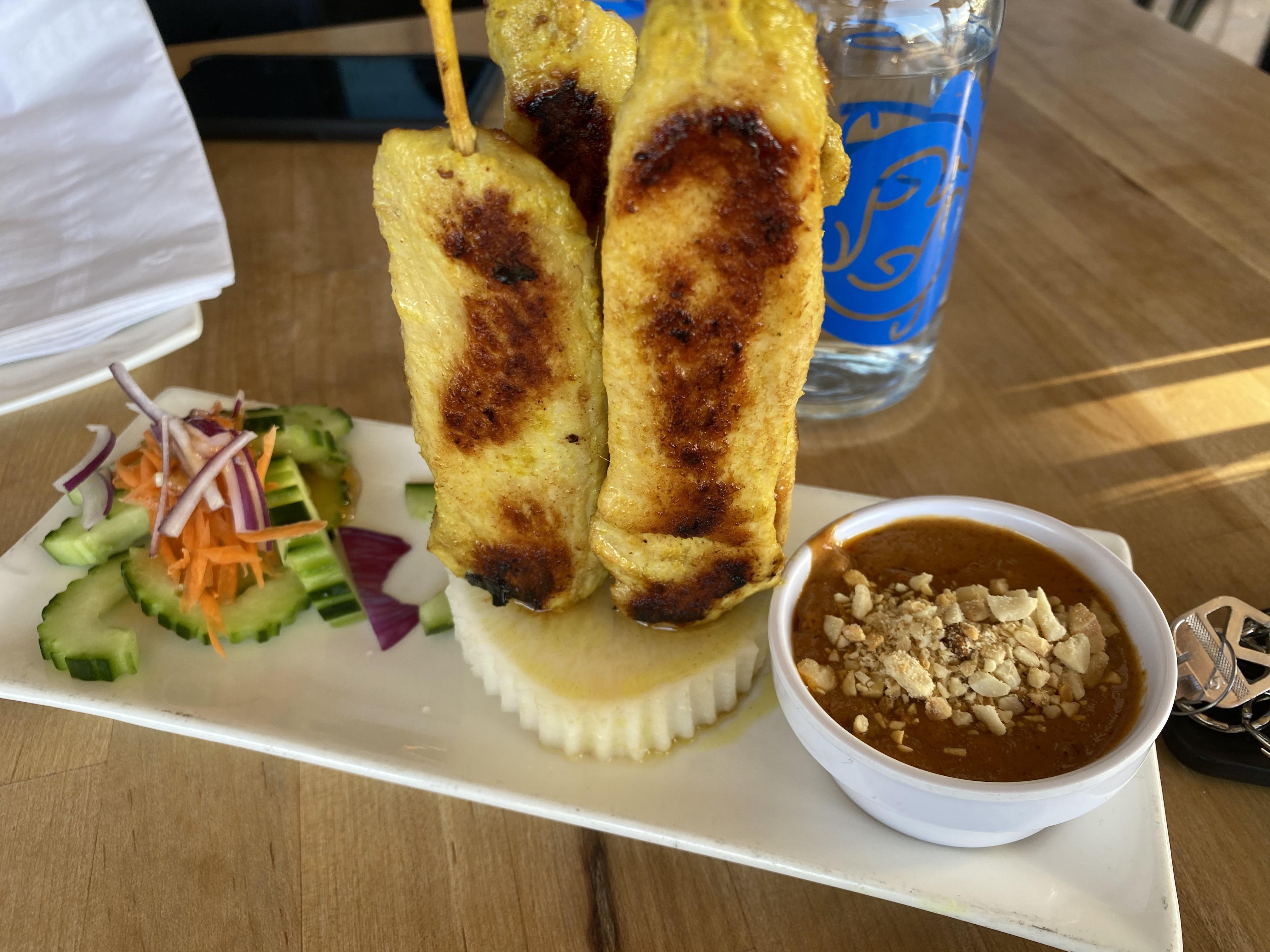 Chicken sateè with peanut sauce, cucumbers, carrots and onions | Scrolller