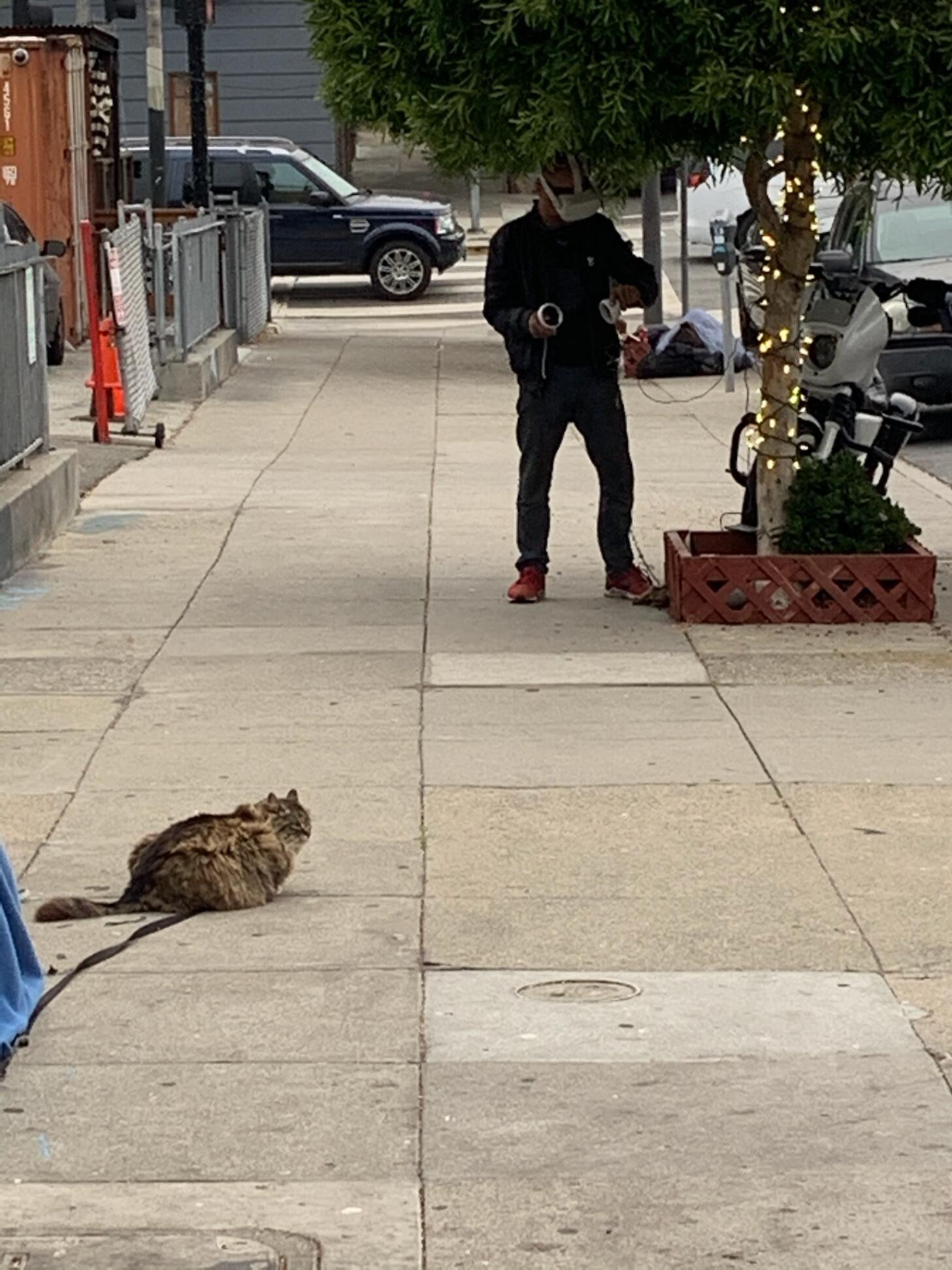 Homeless person playing VR on a San Francisco street, charging it via ...