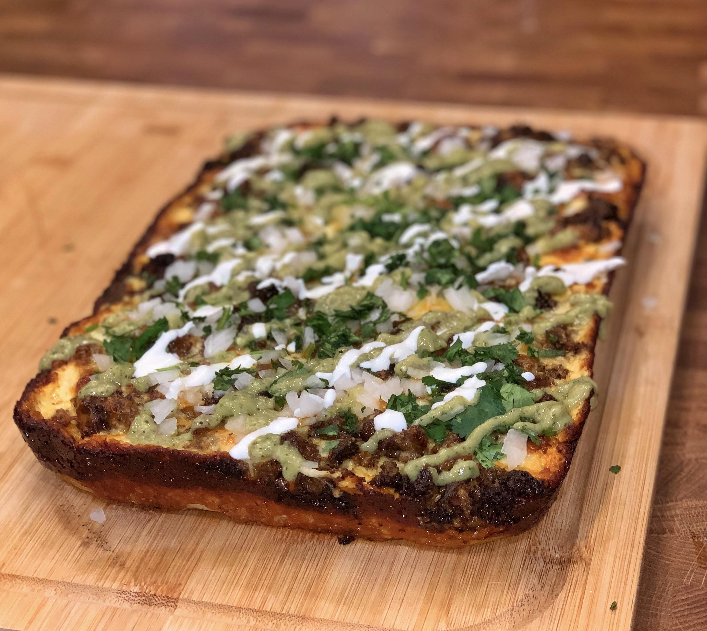 Homemade Birria Pizza Detroit style with freshly made avo salsa and