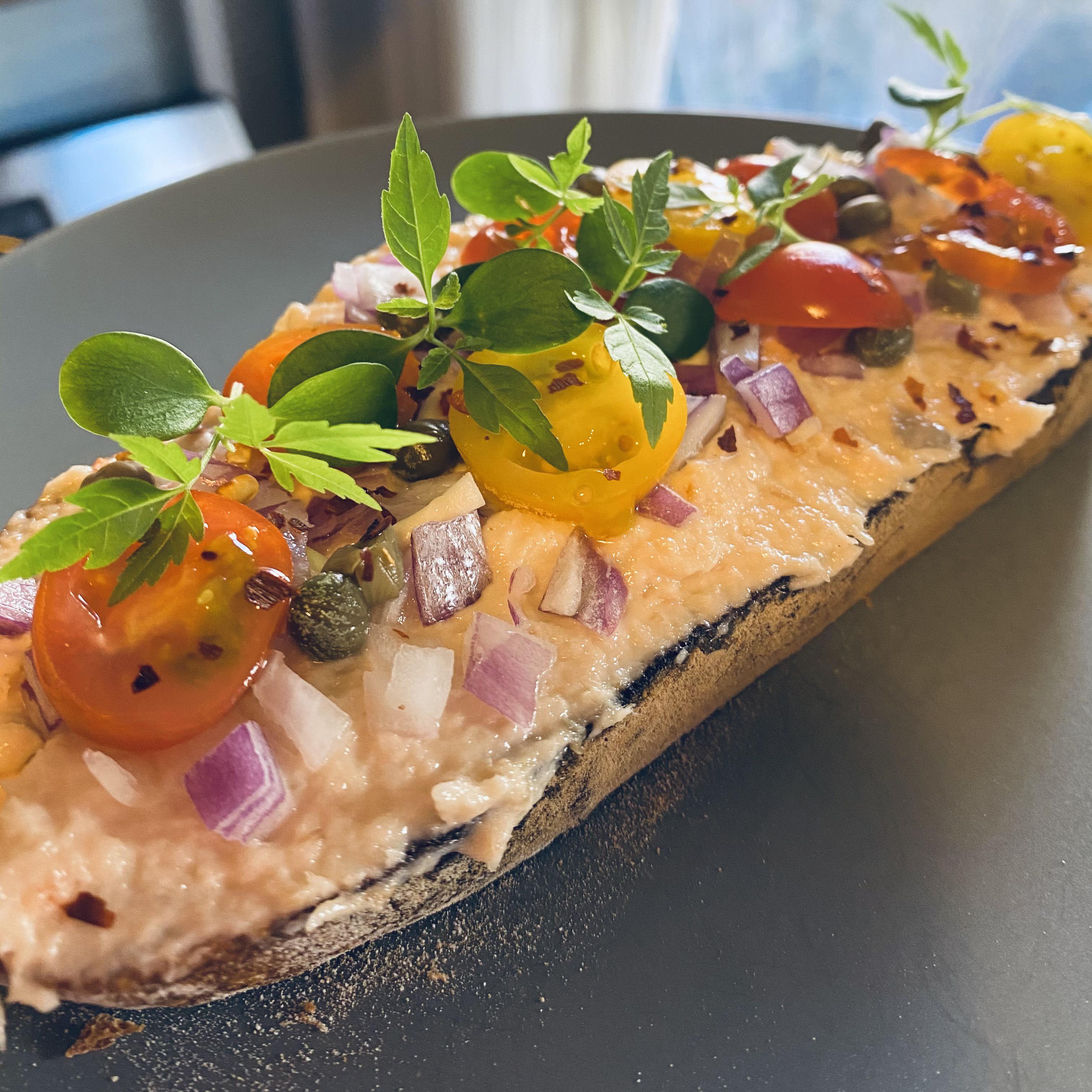 Homemade Sourdough with smoked salmon spread, capers, cherry tomatoes