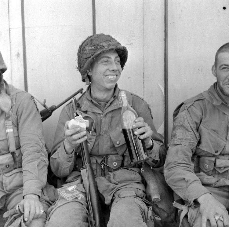 Paratrooper of the 101st Airborne enjoying some French wine and cheese ...