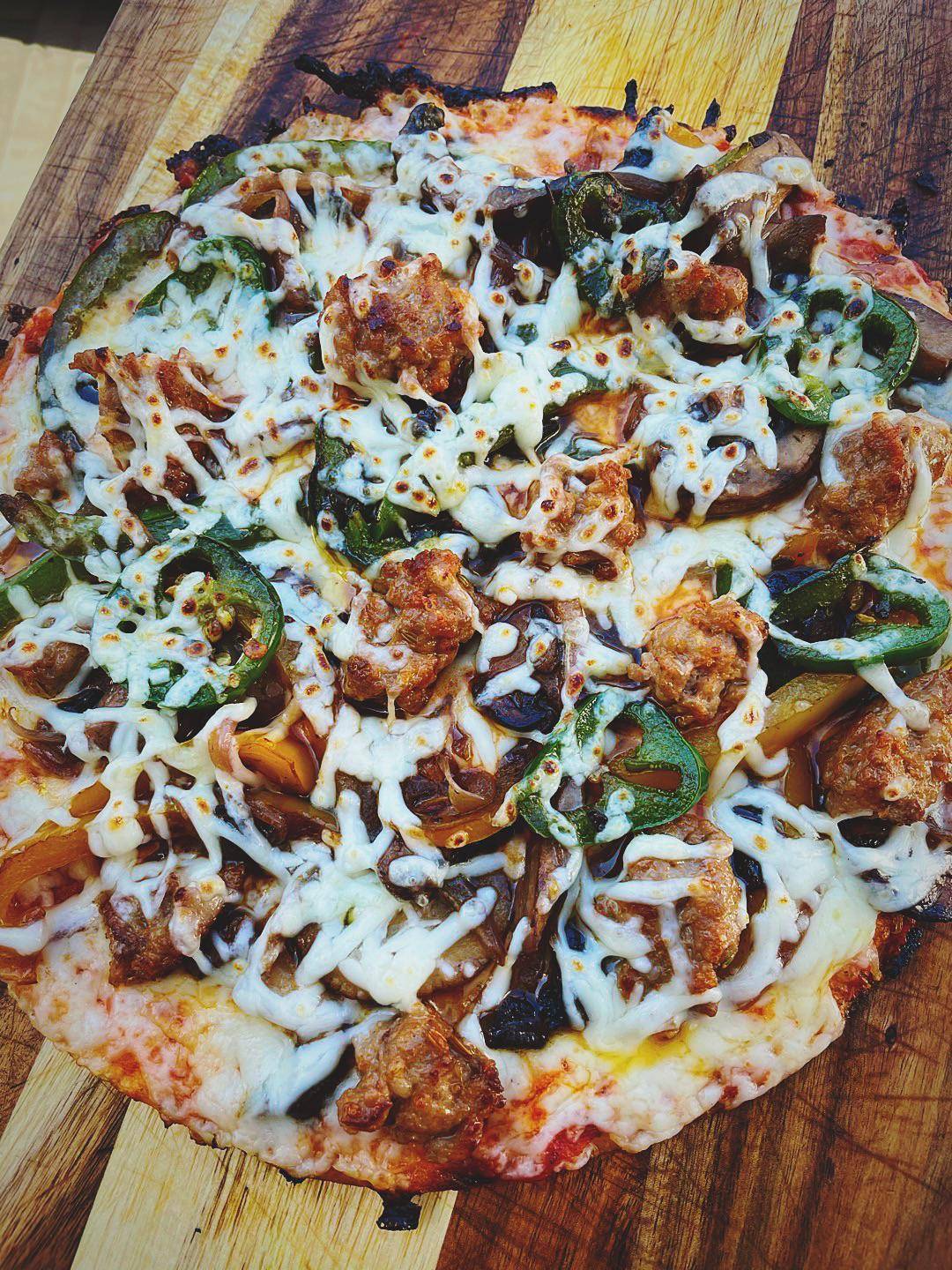 Sausage, pepper, onion, mushroom, jalapeño tortilla pizza. Scrolller
