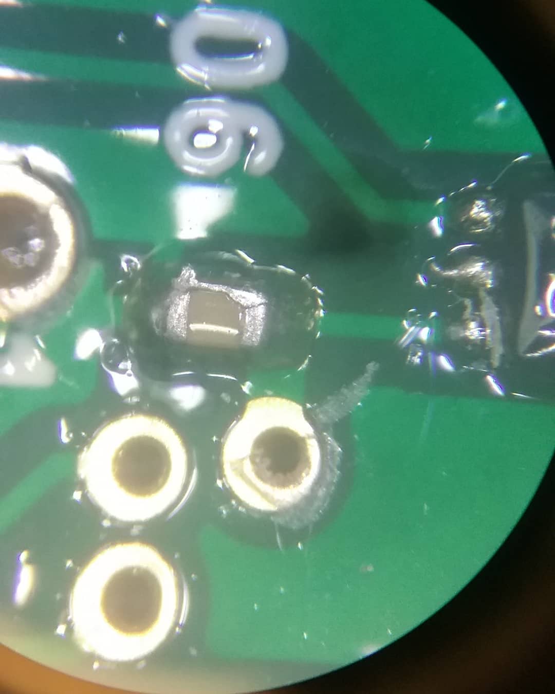 Solder bridge across an 0402 capacitor Scrolller