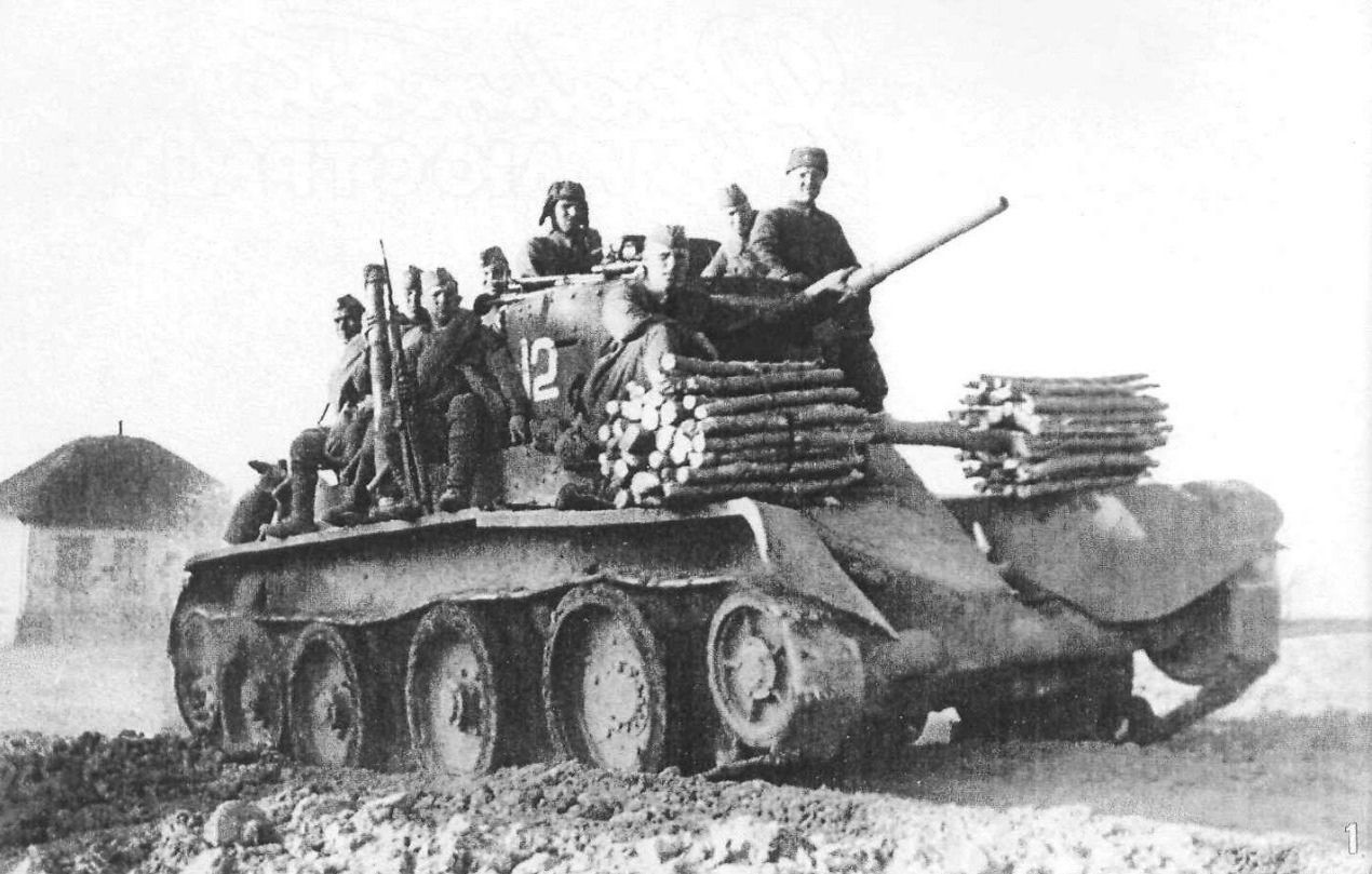 Soviet infantry riding a BT5 tank with some wooden logs attached to it