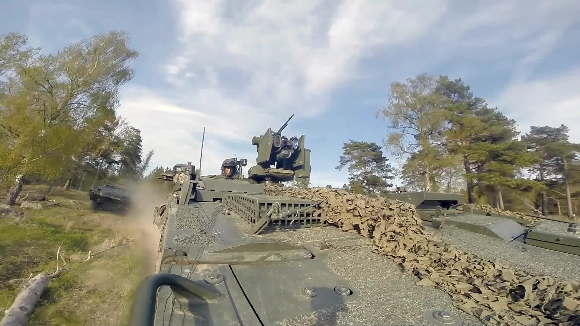 Swedish Patria AMV maneuvering through the terrain, drone shots | Scrolller